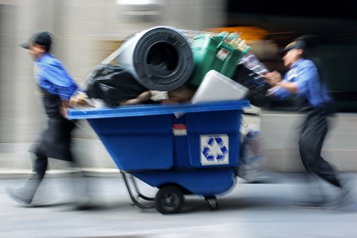 Operatives loading rubbish into a Luton van during a commercial clearance